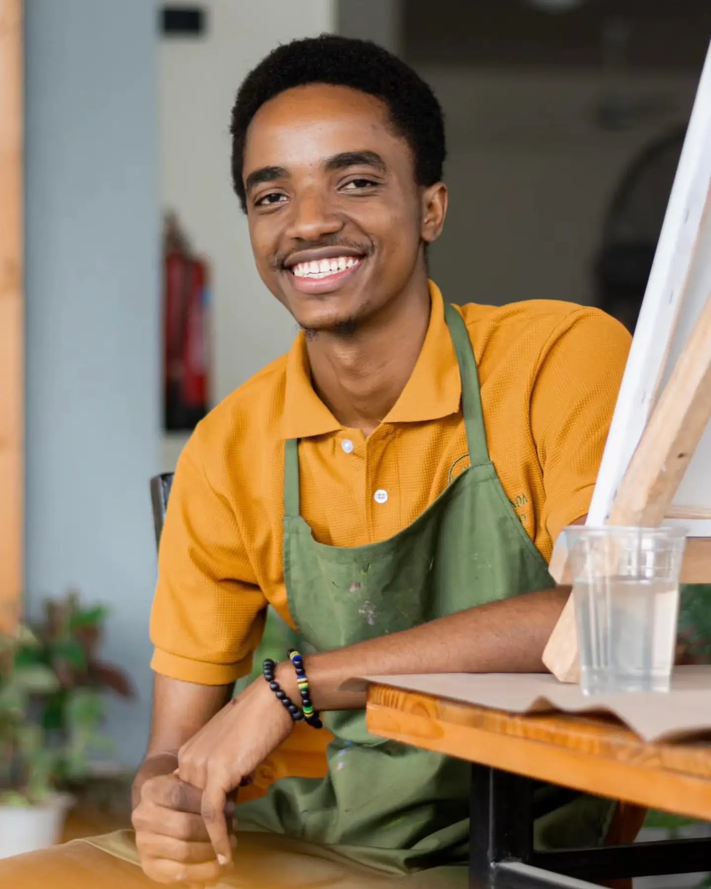 Henry Kirenga, Artist specializing in Portraits & Mixed Media - Professional portrait showing the artist in their creative environment